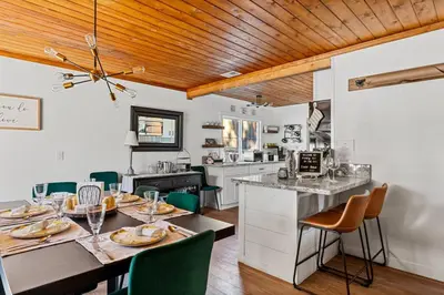 a kitchen and dining room with a table and chairs at Honeybee by the Bay in Big Bear Lake in Big Bear Lake