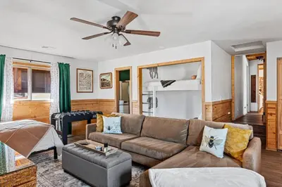 a living room with a couch and a ceiling fan at Honeybee by the Bay in Big Bear Lake in Big Bear Lake
