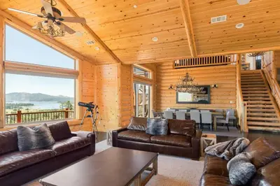 a living room with leather couches and a table at Hidden Haven Estate in Big Bear Lake