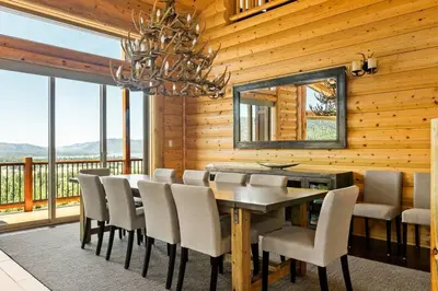 a dining room with a table and chairs and a chandelier at Hidden Haven Estate in Big Bear Lake