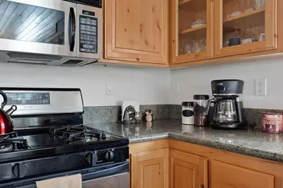 a kitchen with a stove and a microwave at Fallen Leaf Hideaway Castle Estate in Big Bear Lake