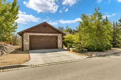 a house with a garage on the side of a street at Fallen Leaf Hideaway Castle Estate in Big Bear Lake