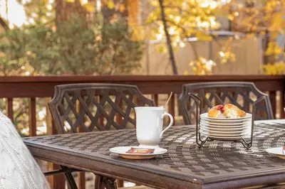 a table with a plate of food and a cup of coffee at Bear Kub Kabin in Big Bear Lake