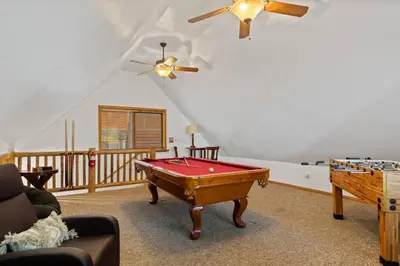 a living room with a pool table and a ceiling fan at Bear Kub Kabin in Big Bear Lake