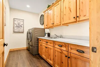 a kitchen with a sink and a refrigerator at Zen Mountain Retreat in Big Bear Lake