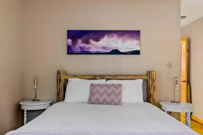 a bedroom with a bed with two nightstands and two tables at The Great Escape in Big Bear Lake