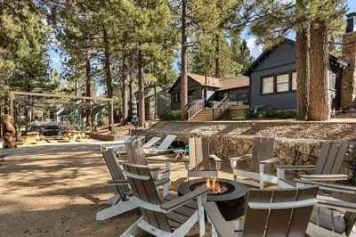 a backyard with chairs and a fire pit and a house at Lakefront View Stunner in Big Bear Lake