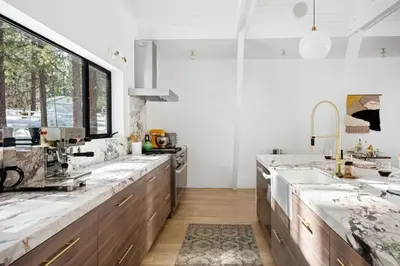 a kitchen with marble counter tops and a sink at Lakefront Modern A Frame in Big Bear Lake