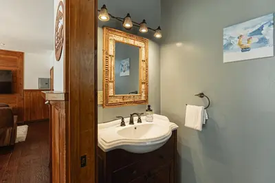 a bathroom with a sink and a mirror at Knoll Lake Cabin in Big Bear Lake in Big Bear Lake