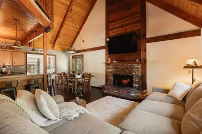 a living room with a couch and a fireplace at Knoll Lake Cabin in Big Bear Lake in Big Bear Lake
