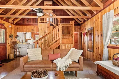 a living room with a couch and a ceiling fan at Tree Top Ranch in Big Bear Lake