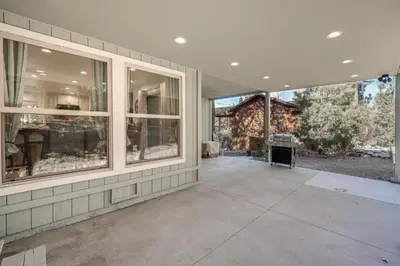 an empty porch of a house with windows at Serene Pine Mountain Club Home with Pool Access! in Pine Mountain Club