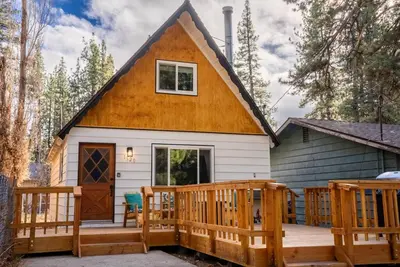 a tiny house with a porch and a deck at The Teddy Bear Cabin! Large Patio! in Big Bear City