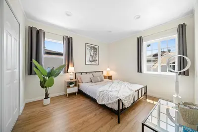 a bedroom with a bed and a glass table at Spacious 3Bdr Home close to Manhattan Beach in Lawndale