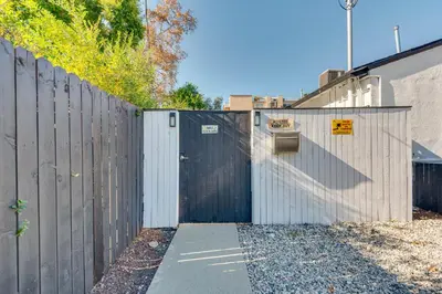 a gate in a fence with a driveway at Van Nuys Abode with Patio, 7 Mi to Universal Studios in Van Nuys