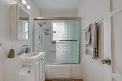 a white bathroom with a shower and a sink at Van Nuys Abode with Patio, 7 Mi to Universal Studios in Van Nuys