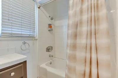 a bathroom with a shower curtain and a tub and a sink at North Hollywood Getaway 14 Mi to Downtown! in North Hollywood