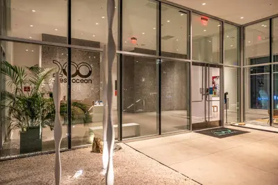 a large glass building with a potted plant in front of it at @ Marbella Lane - Grand 2BR w/ Beach & Ocean Views in Long Beach