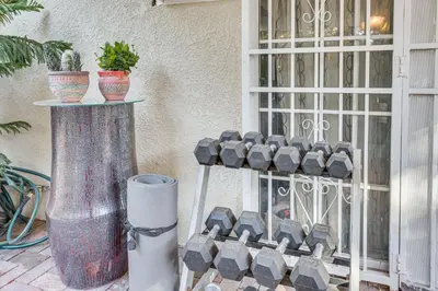 a gate with some vases on the side of a building at Los Angeles Apartment with Patio, 4 Mi to Downtown! in Los Angeles