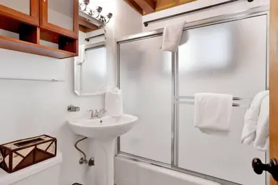 a bathroom with a shower and a sink at Kozy Cabin Big Bear~ Walk to Village & Lake Cottage~ in Big Bear Lake