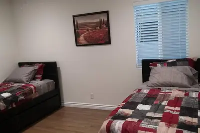 a bedroom with two beds and a picture on the wall at Family getaway 3 BR 2 Bath home in Lomita, CA. in Los Angeles
