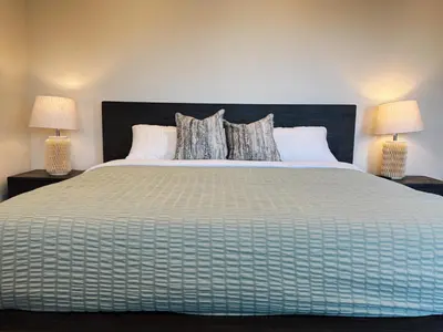 a bedroom with a large bed with two lamps at Hollywood Hills Haven-Guest House in Los Angeles