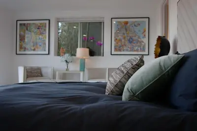 a blue bed with pillows in a bedroom at Skyline Serenity Luxe Suite-Private Room in Los Angeles