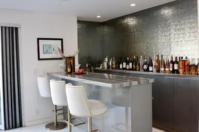 a bar with white chairs and a counter with bottles at Skyline Serenity Luxe Suite-Private Room in Los Angeles
