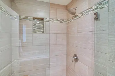 a bathroom with a shower with a glass door at Huntington Beach Condo - Walk to the Ocean! in Huntington Beach