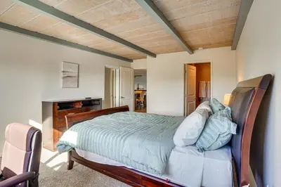 a bedroom with a bed with a wooden head board at Huntington Beach Condo - Walk to the Ocean! in Huntington Beach