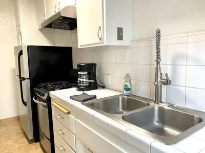 a kitchen with a sink and a stove at Beach Gateway Full Kitchen 1 Bedroom Duplex in Manhattan Beach