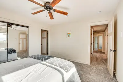 a bedroom with a bed and a ceiling fan at Expansive Mountain Gem Game Room, 3 Mi to Acton in Ravenna