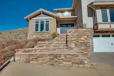 a house with a stone staircase in front of a house at Expansive Mountain Gem Game Room, 3 Mi to Acton in Ravenna