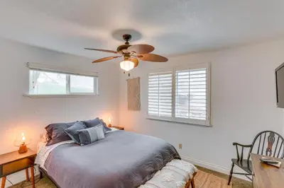 a bedroom with a bed and a ceiling fan at Mid-Century Mod Cottage, Steps to Lake Gregory! in Crestline