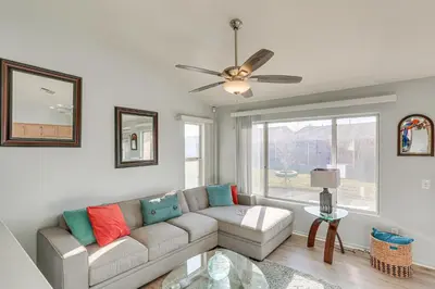 a living room with a couch and a window at Victorville Home with Fenced Backyard and Patio! in Victorville