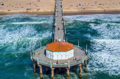 an aerial view of a pier on the beach at Brand New Ocean-View Beach Home Steps to the Sand! in Manhattan Beach