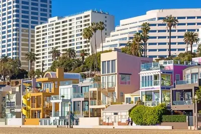 a group of buildings with palm trees and buildings at 2 Santa Monica Beach Walking in Los Angeles