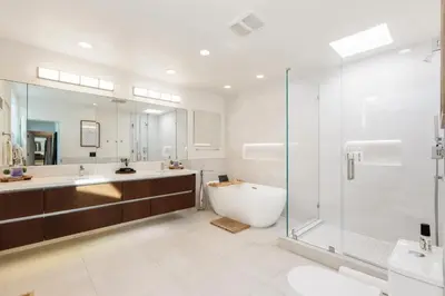 a bathroom with a tub and a glass shower at Malibu Breeze - hot tub, ocean view, steps to beach in Malibu