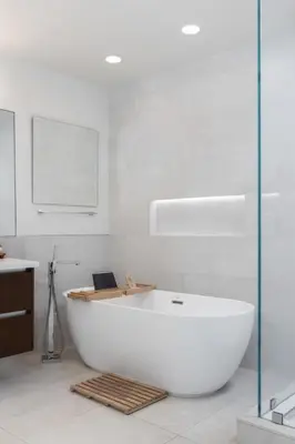 a large white bath tub sitting in a bathroom at Malibu Breeze - hot tub, ocean view, steps to beach in Malibu