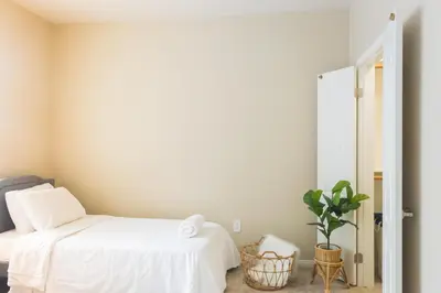 a bedroom with two beds and a potted plant at Sunny Living l Walk to the Marina in Los Angeles