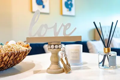 a table with a candle and a basket on it at Sunny Living l Walk to the Marina in Los Angeles
