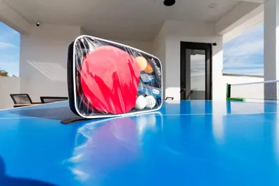 a suitcase sitting on top of a tennis court at Brand New Modern 5 Bedroom House Pickfair Village in Los Angeles