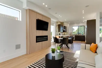 a living room with a couch and a table at Brand New Modern 4 Bedroom House Pickfair Village in Los Angeles