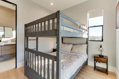 a bedroom with a bunk bed and a bathroom at Brand New Modern 4 Bedroom House Pickfair Village in Los Angeles