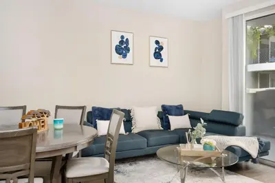 a living room with a blue couch and a table at Charming & Peaceful l 1 bedroom in Marina Del Rey, CA in Los Angeles