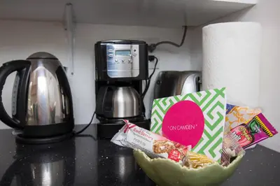 a bowl of food on a counter next to a coffee maker at Beverly Hills Celebrity Home in Los Angeles