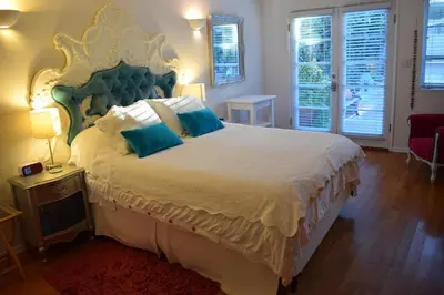 a bedroom with a large bed with a large headboard at Beverly Hills Celebrity Home in Los Angeles