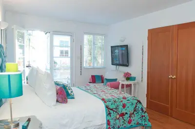 a bedroom with a bed and a tv on the wall at Beverly Hills Celebrity Home in Los Angeles