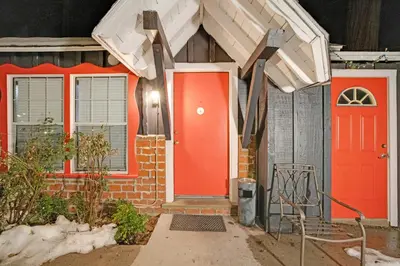 an orange front door of a house at Arrowhead Tree Top Lodge in Lake Arrowhead