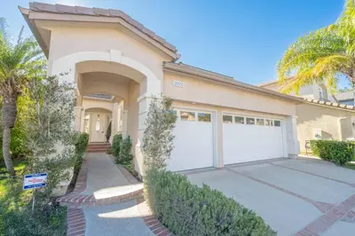 a house with a garage and palm trees at ৎ୭The safty paradiseৎ୭ H/w Pool Jacuzzi &much more in Los Angeles